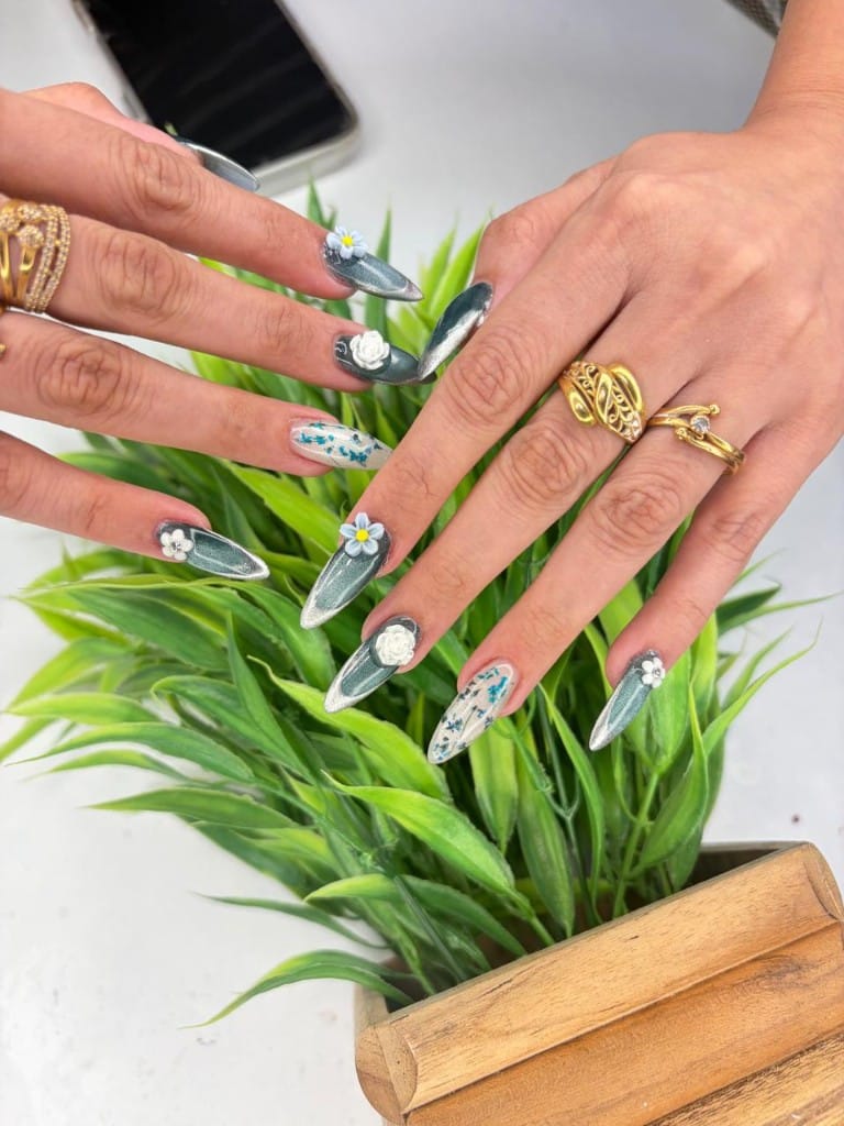 Teal magnetic cat-eye nails with dried flower encapsulation and 3D roses