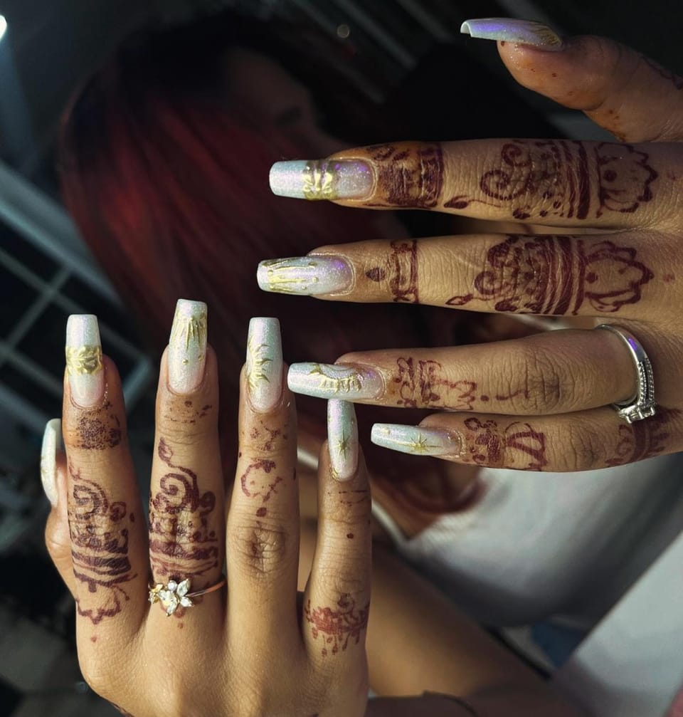 Holographic white nails with gold celestial art and mehendi accents