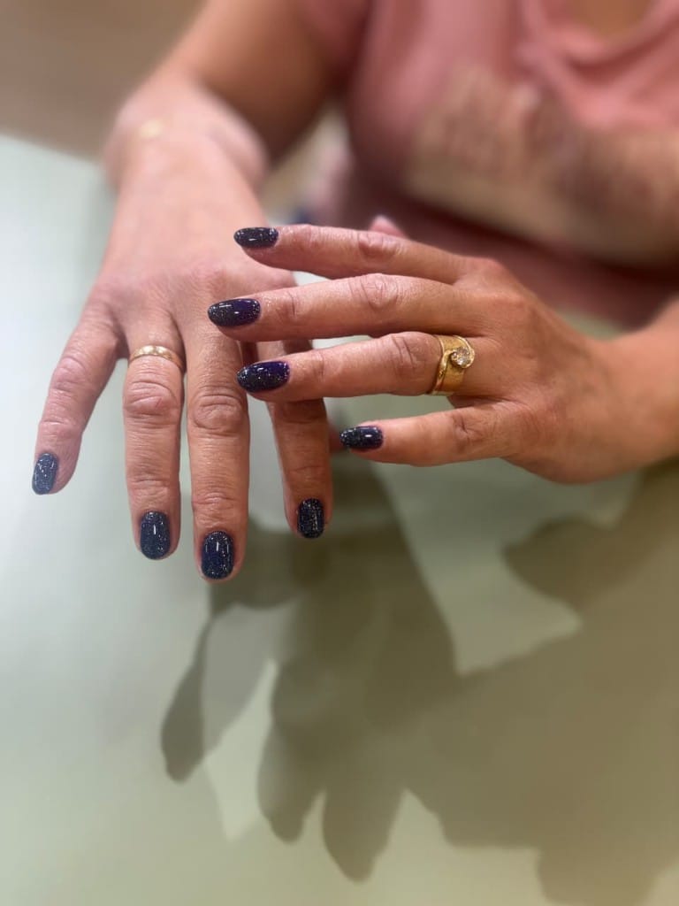 Midnight navy oval nails with holographic silver glitter shimmer